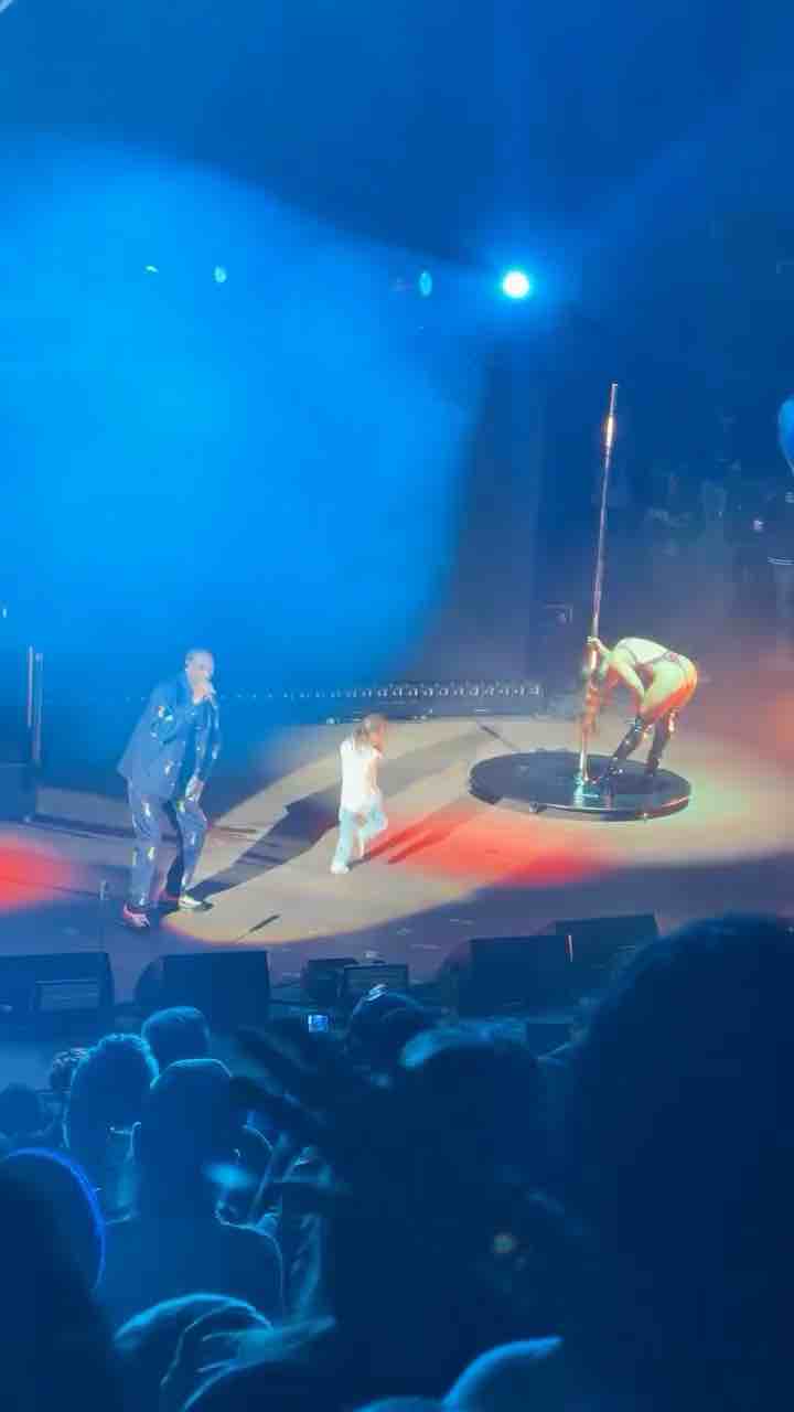 Snoop Dogg performing Drop It Like It’s Hot with a stripper / pole dancer on stage. I’m concerned about the kid on stage